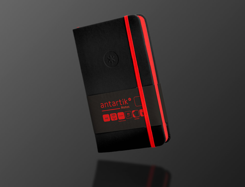 CARNET A6 ANTARTIK NOTES PAPIER UNI IVOIRE COUVERTURE RIGIDE FERMETURE ELASTIQUE ROUGE 100 PAGES 80GR COLORIS NOIR